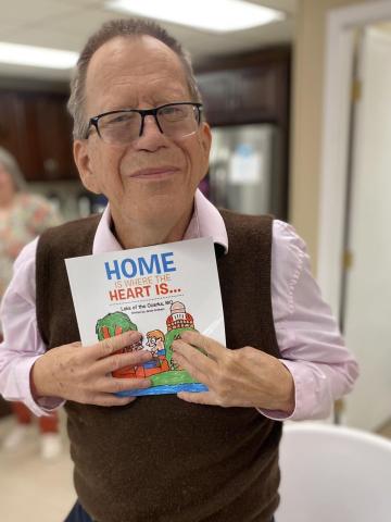 Jamie Graham with his newest book, "Home is Where the Heart is, Lake of the Ozark, MO